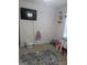 Bedroom with a TV mounted on the wall, basket, and gray area rug at 1524 Queen Elizabeth Dr, Locust Grove, GA 30248