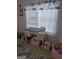 Bedroom with a desk, toys, and gray area rug near a large window at 1524 Queen Elizabeth Dr, Locust Grove, GA 30248