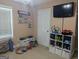 bedroom with TV, toy storage, and bookshelf with decoratively arranged books at 1524 Queen Elizabeth Dr, Locust Grove, GA 30248