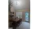 Dining area with a wooden table, and an exterior view to the back deck at 1524 Queen Elizabeth Dr, Locust Grove, GA 30248