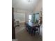 This dining room features a large wooden table with 6 chairs and natural light at 1524 Queen Elizabeth Dr, Locust Grove, GA 30248