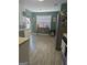 Bright kitchen with wood grain tile floor, stainless steel appliances, and a view to the backyard at 1524 Queen Elizabeth Dr, Locust Grove, GA 30248