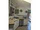 Well-lit kitchen featuring white cabinets and stainless steel appliances at 1524 Queen Elizabeth Dr, Locust Grove, GA 30248
