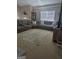 Spacious living room area with carpet flooring and large sectional sofa at 1524 Queen Elizabeth Dr, Locust Grove, GA 30248