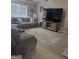 Comfortable living room with plush seating and a large television for entertainment at 1524 Queen Elizabeth Dr, Locust Grove, GA 30248