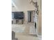 Bright living area featuring a fireplace and a large television for entertainment at 1524 Queen Elizabeth Dr, Locust Grove, GA 30248