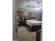Main bedroom featuring a tray ceiling, a king sized bed, and en suite bathroom at 1524 Queen Elizabeth Dr, Locust Grove, GA 30248