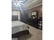 Bedroom featuring a king bed, a ceiling fan and dark wood furnishings at 1524 Queen Elizabeth Dr, Locust Grove, GA 30248