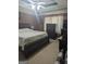 Main bedroom with a king-sized bed, ceiling fan and dark wood furniture at 1524 Queen Elizabeth Dr, Locust Grove, GA 30248