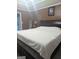 Main bedroom featuring a king bed, en suite bath, and a view to the bathroom at 1524 Queen Elizabeth Dr, Locust Grove, GA 30248