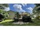 A view of the back of the house, including a wooden deck, and greenery at 8436 Magnolia Dr, Jonesboro, GA 30238