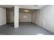 Finished basement with light walls, light ceiling and gray painted floor at 8436 Magnolia Dr, Jonesboro, GA 30238