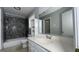 Bathroom with tiled shower, white vanity and mirror at 8436 Magnolia Dr, Jonesboro, GA 30238