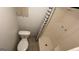 Bathroom with a toilet and shower-tub combination with shower curtain at 8436 Magnolia Dr, Jonesboro, GA 30238