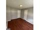 A standard bedroom has two doors, wood-look floors and light gray walls at 8436 Magnolia Dr, Jonesboro, GA 30238