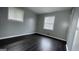 A light-filled bedroom with wood-look floors and modern window at 8436 Magnolia Dr, Jonesboro, GA 30238