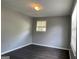 A standard bedroom has dark floors, gray walls, and a bright window at 8436 Magnolia Dr, Jonesboro, GA 30238