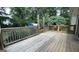 Wooden deck with railings surrounded by trees at 8436 Magnolia Dr, Jonesboro, GA 30238