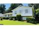 A well-maintained home with mature shrubs, manicured lawn, and a satellite dish at 8436 Magnolia Dr, Jonesboro, GA 30238