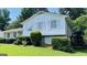 The exterior of this home features white siding, brick accents, and a well-manicured lawn at 8436 Magnolia Dr, Jonesboro, GA 30238