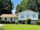 Charming home with a well manicured lawn and shuttered windows at 8436 Magnolia Dr, Jonesboro, GA 30238