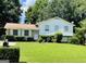 Charming home with a lush front yard, well-maintained landscaping, and classic white shutters at 8436 Magnolia Dr, Jonesboro, GA 30238