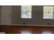 Bright living room featuring hardwood floors, neutral walls, and large windows at 8436 Magnolia Dr, Jonesboro, GA 30238
