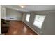 Bright living room featuring hardwood floors, neutral walls, and large windows at 8436 Magnolia Dr, Jonesboro, GA 30238