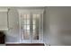 Living room featuring a pair of decorative glass doors and neutral paint at 8436 Magnolia Dr, Jonesboro, GA 30238