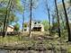 View of the back of the home, featuring a large deck overlooking a wooded lot, providing privacy at 2481 Weatherstone Cir, Conyers, GA 30094