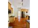 Bright eat-in kitchen features wood cabinets, granite counters, modern appliances, and wood floors at 2481 Weatherstone Cir, Conyers, GA 30094