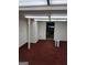 Finished basement space with drop ceiling, carpeted floors, and a support column at 177 Northwind Sw Ct, Lilburn, GA 30047