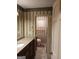 Traditional bathroom featuring granite counters, dark cabinets and decorative wallpaper at 177 Northwind Sw Ct, Lilburn, GA 30047