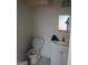 Bathroom with standard toilet, vanity sink with storage, and neutral wall color at 177 Northwind Sw Ct, Lilburn, GA 30047