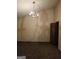 Bedroom features carpeted floors, a chandelier, and a wooden door at 177 Northwind Sw Ct, Lilburn, GA 30047