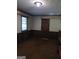 Bedroom features paneled walls, carpeted flooring, and a window for natural light at 177 Northwind Sw Ct, Lilburn, GA 30047