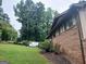 Brick home exterior with a well-maintained lawn and partial view of the roof and windows at 177 Northwind Sw Ct, Lilburn, GA 30047
