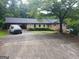 Charming single-story home with a spacious driveway and traditional brick facade at 177 Northwind Sw Ct, Lilburn, GA 30047