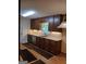 Kitchen boasts granite countertops, stainless steel appliances, and dark wood cabinets at 177 Northwind Sw Ct, Lilburn, GA 30047