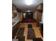 Spacious kitchen featuring wooden cabinets and granite countertops leading to a living area at 177 Northwind Sw Ct, Lilburn, GA 30047