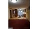 Inviting open-plan living area with hardwood and red carpet flooring at 177 Northwind Sw Ct, Lilburn, GA 30047