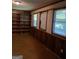 Spacious living area featuring dark paneling, built-in shelving, and ample natural light at 177 Northwind Sw Ct, Lilburn, GA 30047