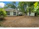 View of the backyard showing a patio area, lawn, and storage shed, with mature trees at 539 Horseshoe Cir, Stockbridge, GA 30281