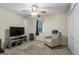 Carpeted bedroom features a ceiling fan and a TV at 539 Horseshoe Cir, Stockbridge, GA 30281
