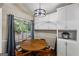 Dining area featuring a window, wood table, and white cabinets at 539 Horseshoe Cir, Stockbridge, GA 30281