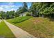 Home's exterior featuring a large, grassy front lawn, shrubbery, and well-maintained sidewalk at 539 Horseshoe Cir, Stockbridge, GA 30281