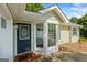Home exterior with a blue front door, brick accents, and bay window with white trim at 539 Horseshoe Cir, Stockbridge, GA 30281