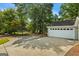 Spacious two-car garage with extended driveway, and mature trees in the background at 539 Horseshoe Cir, Stockbridge, GA 30281