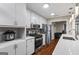 Modern kitchen features stainless steel appliances, white cabinets, and stone countertops at 539 Horseshoe Cir, Stockbridge, GA 30281