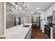Bright kitchen open to dining and living area features a stone countertop island and stainless appliances at 539 Horseshoe Cir, Stockbridge, GA 30281